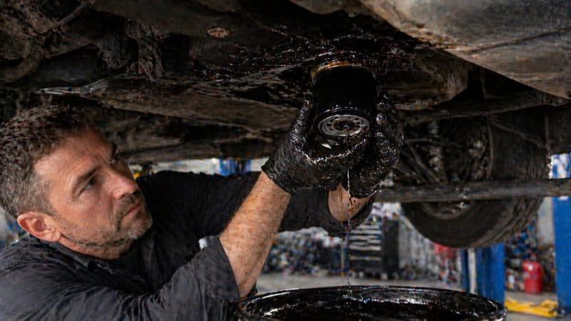 Mechanic working under lifted vehicle